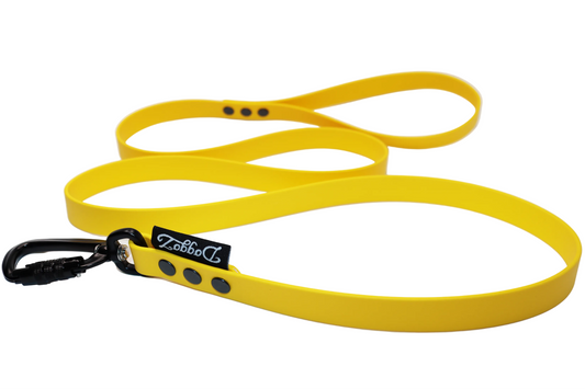 A bright Yellow Sunflower BioThane dog leash with a black aluminum locking carabiner, matching black rivets, and the DoggoZ brand label, displayed on a white background.