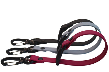 Side view of three BioThane Long Line Keepers in Magenta Pink, Husky Blue, and Black, showing the loop design and black carabiner clips used for organizing dog training leads.