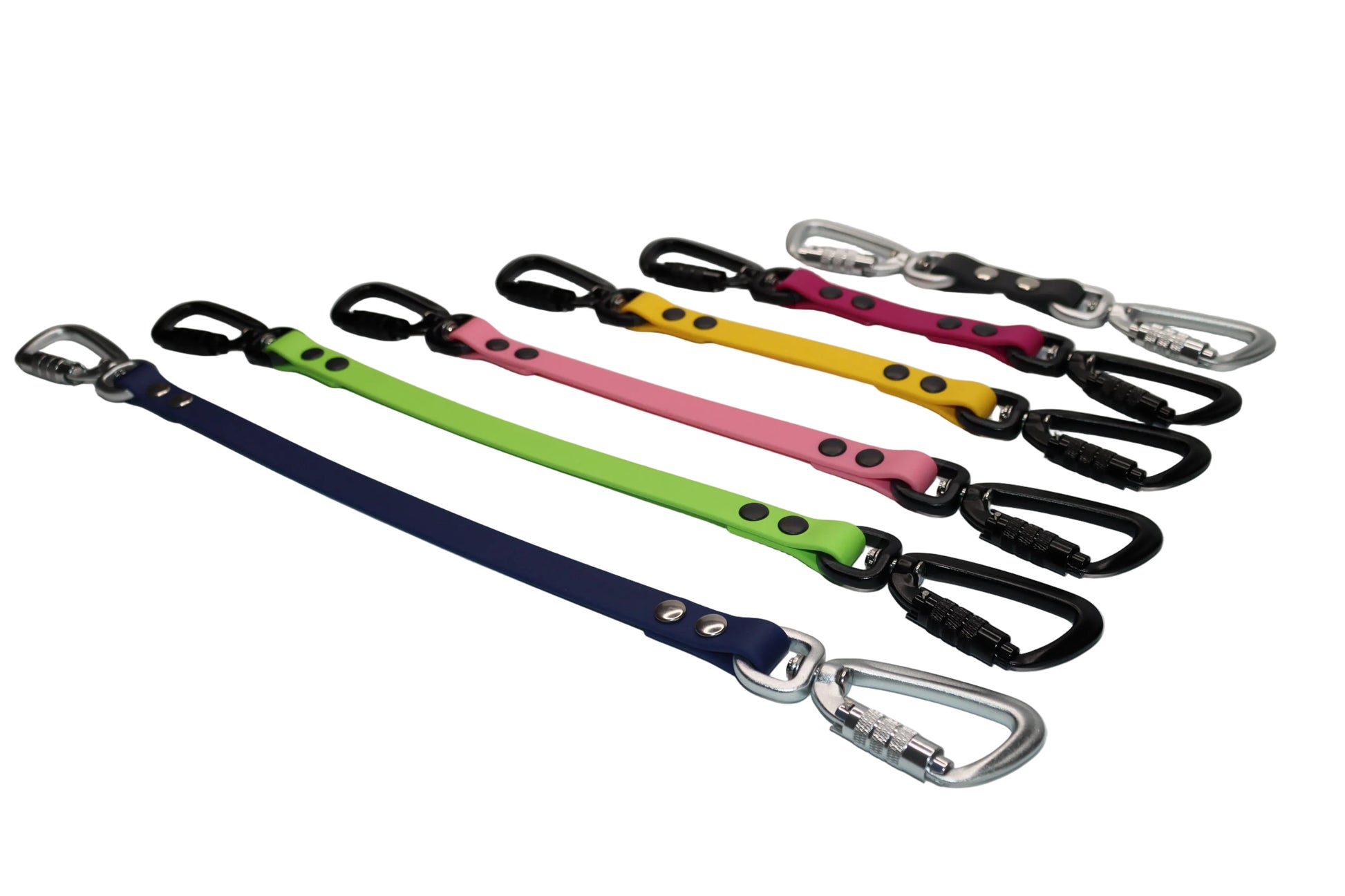 A row of colorful BioThane Safety Straps by DoggoZ, featuring various colors like Navy, Neon Green, Pink, and Yellow. The image showcases the SAFE edition with heavy-duty black autolocking carabiners and silver locking clips. These backup straps serve as an extra security connection between collar and harness for reactive or strong dogs.
